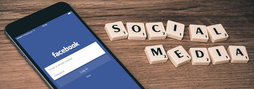 Phone Facebook with social media spelled out