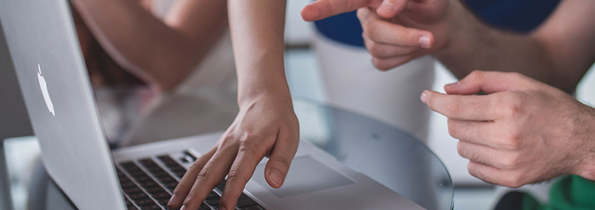 Corporate Employees Pointing At Macbook