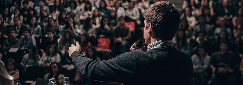 Man Giving Speech To Large Crowd