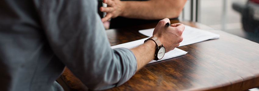 Man Writing During Meeting